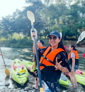 kayaker standing upright with paddle